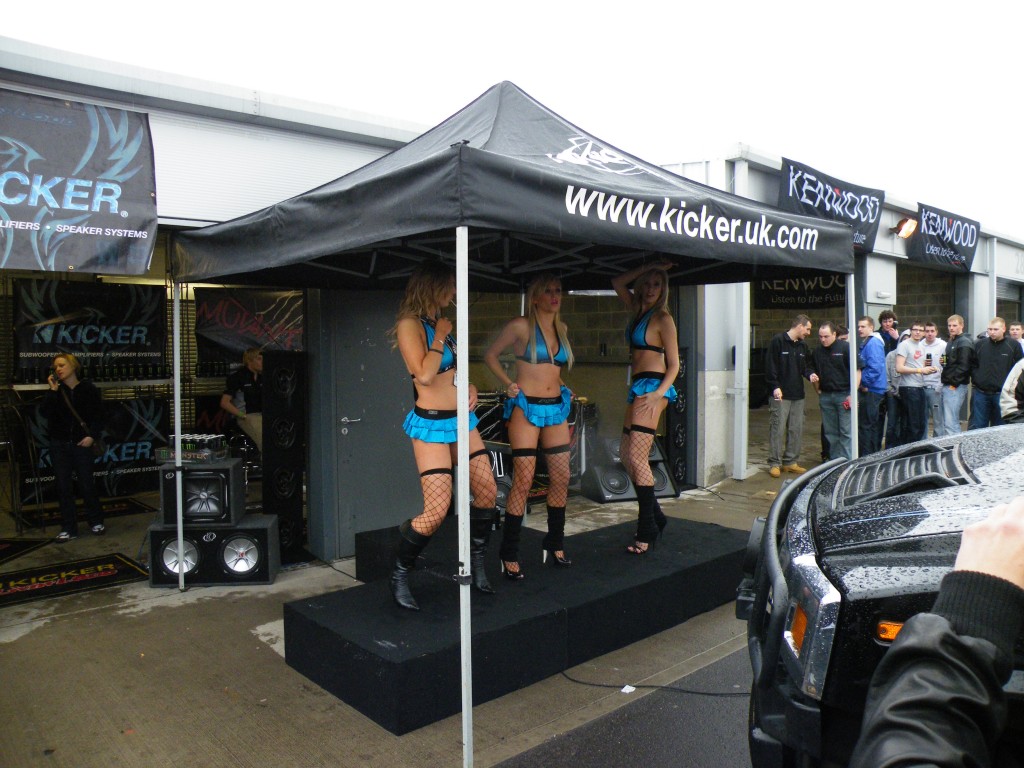 Three Blondes Dancing at a Car Show