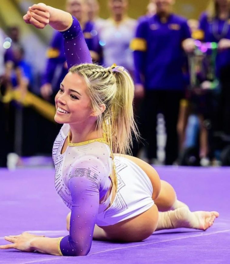 Blonde university gymnast in action